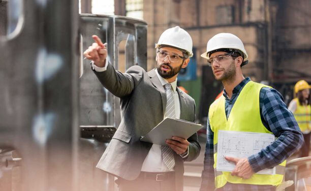 Zwei Mitarbeiter im Facility Management sprechen sich ab – Schaubild für Vertrieb und Operative.